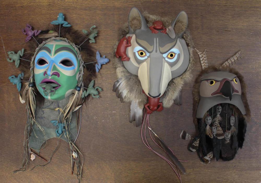 Appraisal: THREE SPIRIT MASK WALL PLAQUES hand painted ceramic with leather