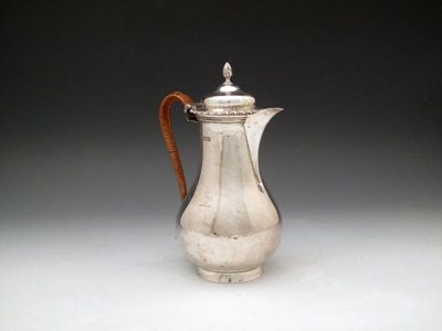 Appraisal: An Edwardian silver hot water pot by John Rawlings London