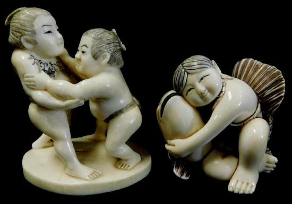 Appraisal: ASIAN Two carved ivory group figures late th early th