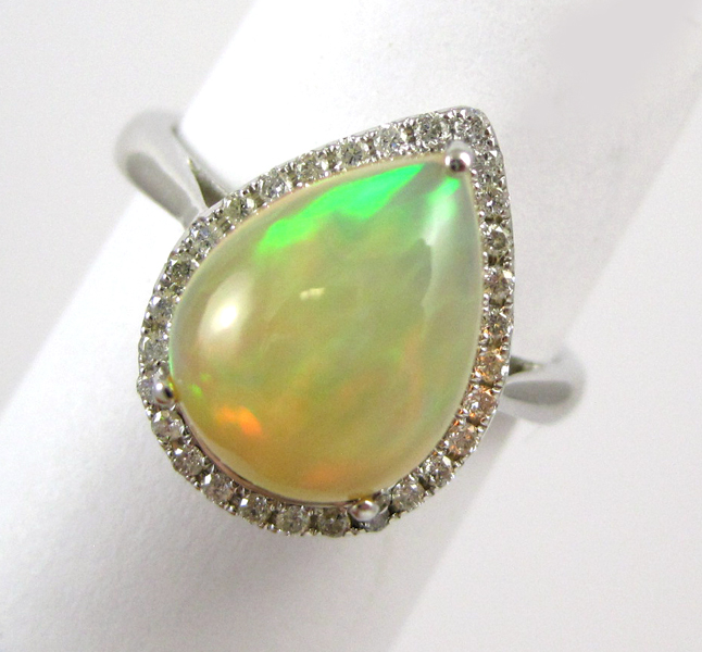 Appraisal: OPAL DIAMOND AND FOURTEEN KARAT WHITE GOLD RING with round-cut