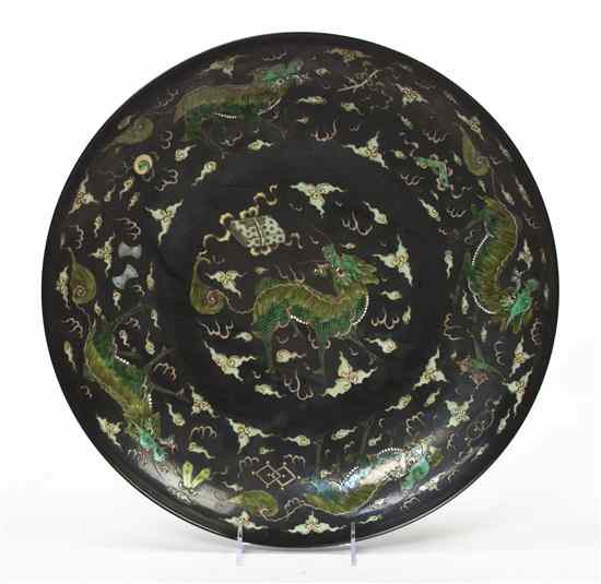 Appraisal: A Chinese Black Porcelain Charger decorated with green dragons and