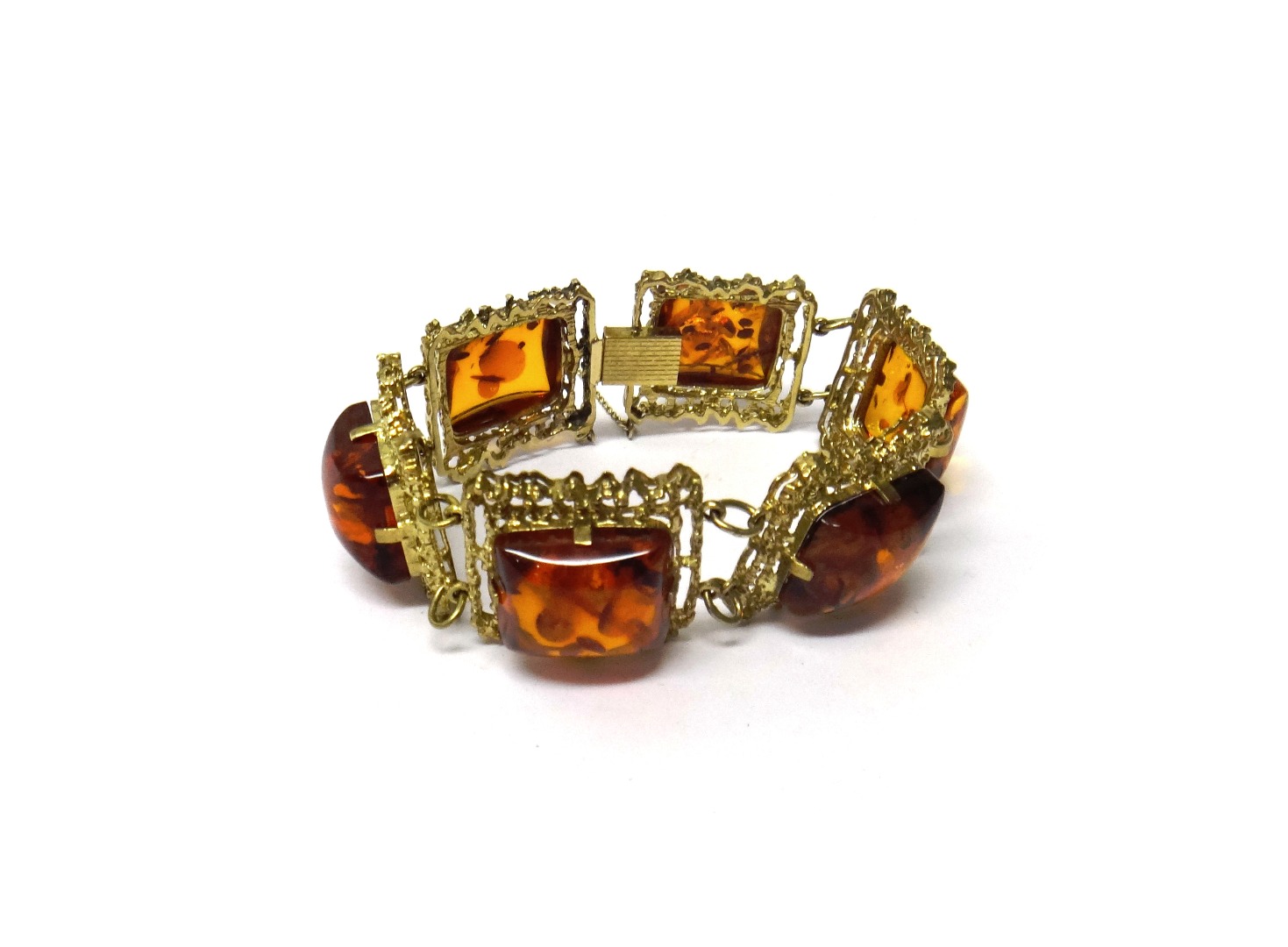 Appraisal: A reconstituted amber panel link bracelet each shaped rectangular link