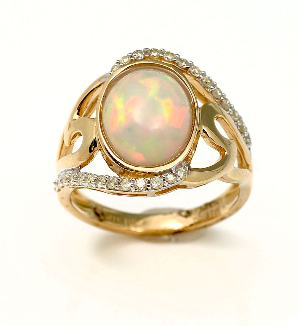 Appraisal: K CT OPAL DIAMOND RING Fiery oval opal cabochon approx