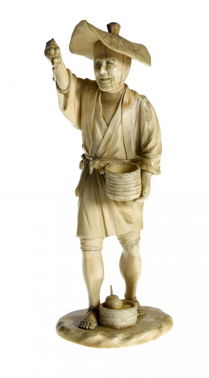 Appraisal: A SECTIONAL IVORY FIGURE OF A FARMER holding a bunch