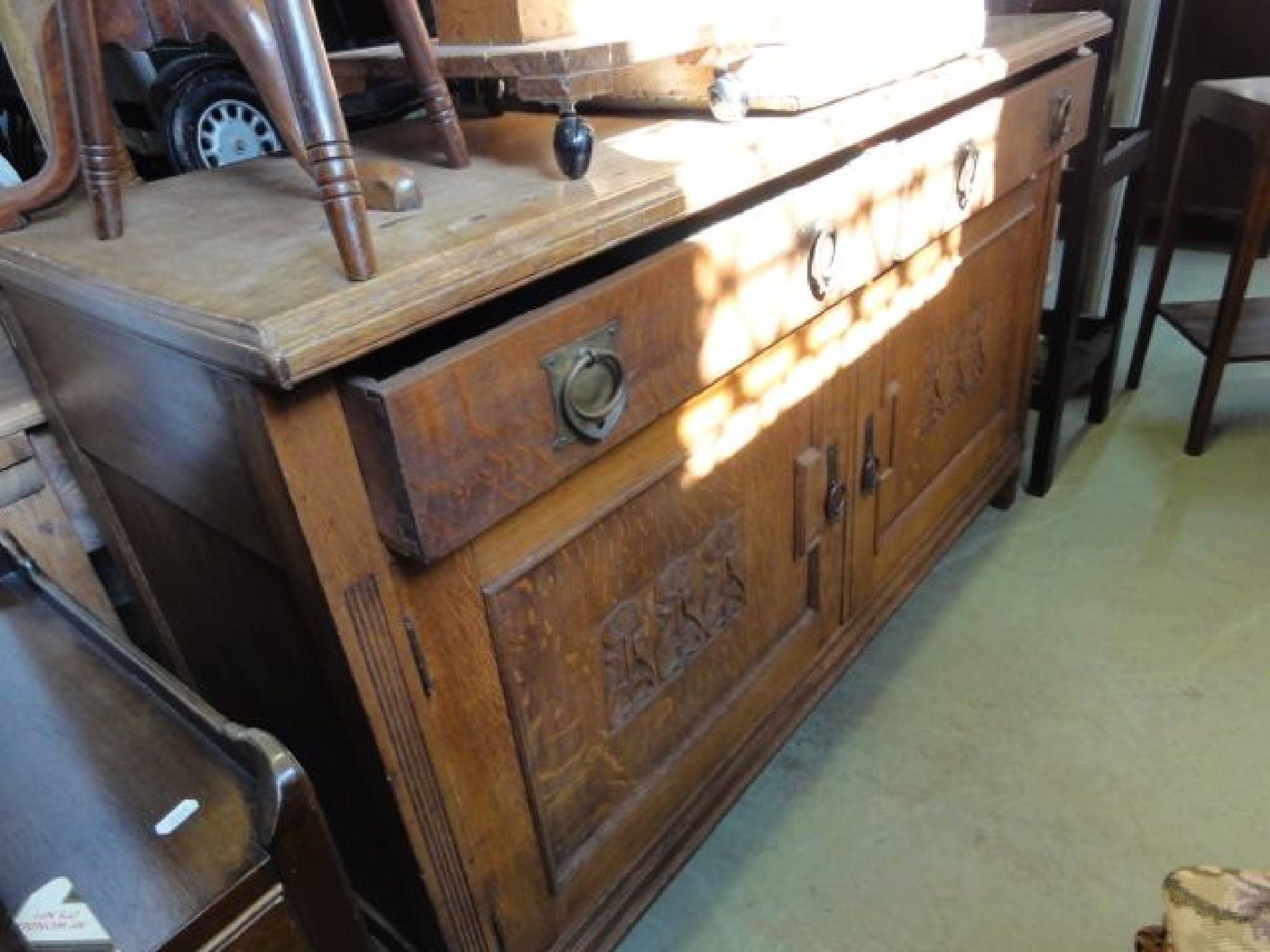 Appraisal: An Arts Crafts oak sideboard enclosed by a pair of