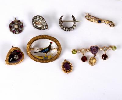 Appraisal: A multi gem set bar brooch centred by an amethyst