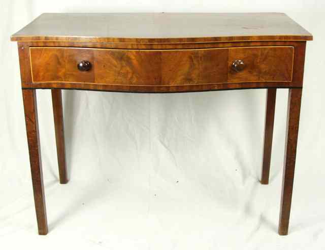 Appraisal: A George III mahogany serpentine side table on square tapering