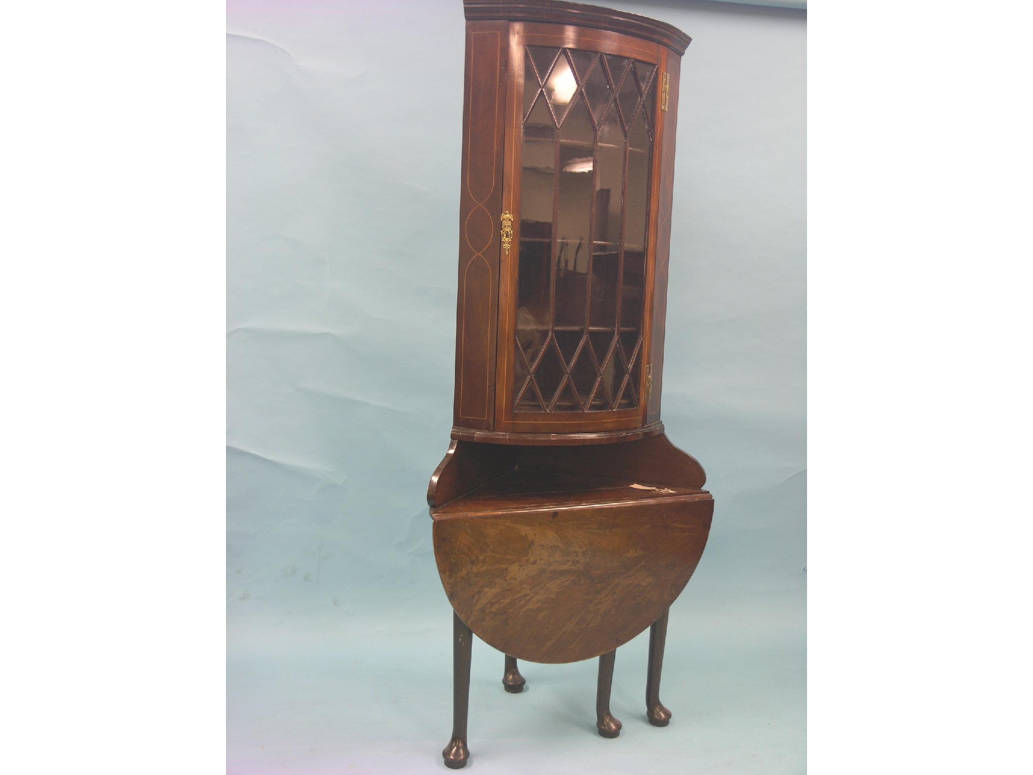 Appraisal: A George III inlaid mahogany corner cabinet convex astragal-glazed door