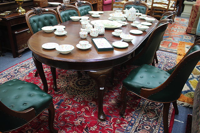 Appraisal: A MAHOGANY WIND OUT EXTENDING DINING TABLE with D shaped