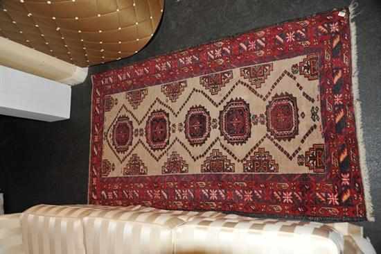 Appraisal: A SMALL PERSIAN RUG IN RED AND CREAM TONES