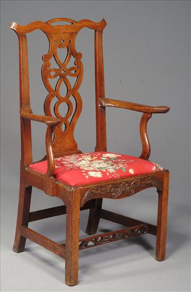 Appraisal: A George III oak armchair circa the rectangular back centered