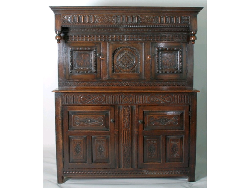 Appraisal: ANTIQUE CARVED AND INLAID OAK COURT CUPBOARD the overhanging canopy