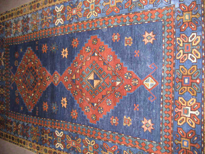 Appraisal: KAZAK AREA RUG The indigo field of scattered star and