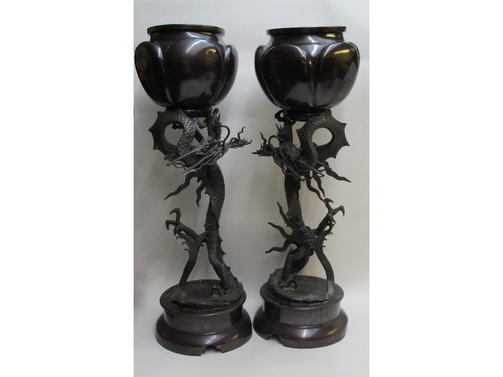 Appraisal: A pair of Japanese bronze planters each lobed bowl supported