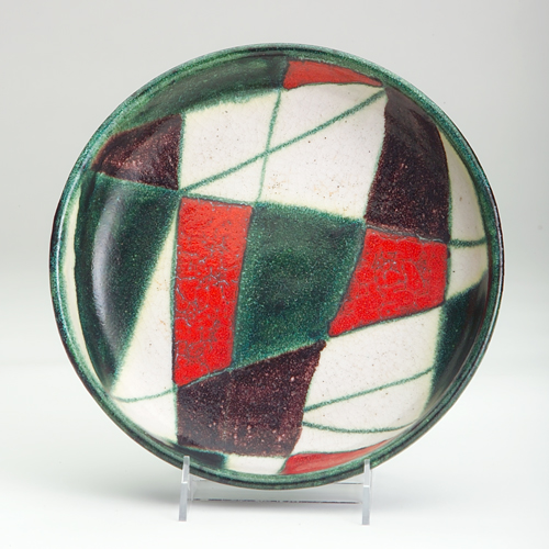 Appraisal: GAMBONE Charger with geometric pattern in bright orange green manganese