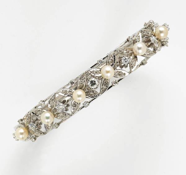 Appraisal: A cultured pearl diamond and fourteen karat white gold bangle