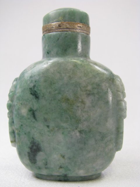 Appraisal: Green jadeite snuff bottle with carvings on the sides and