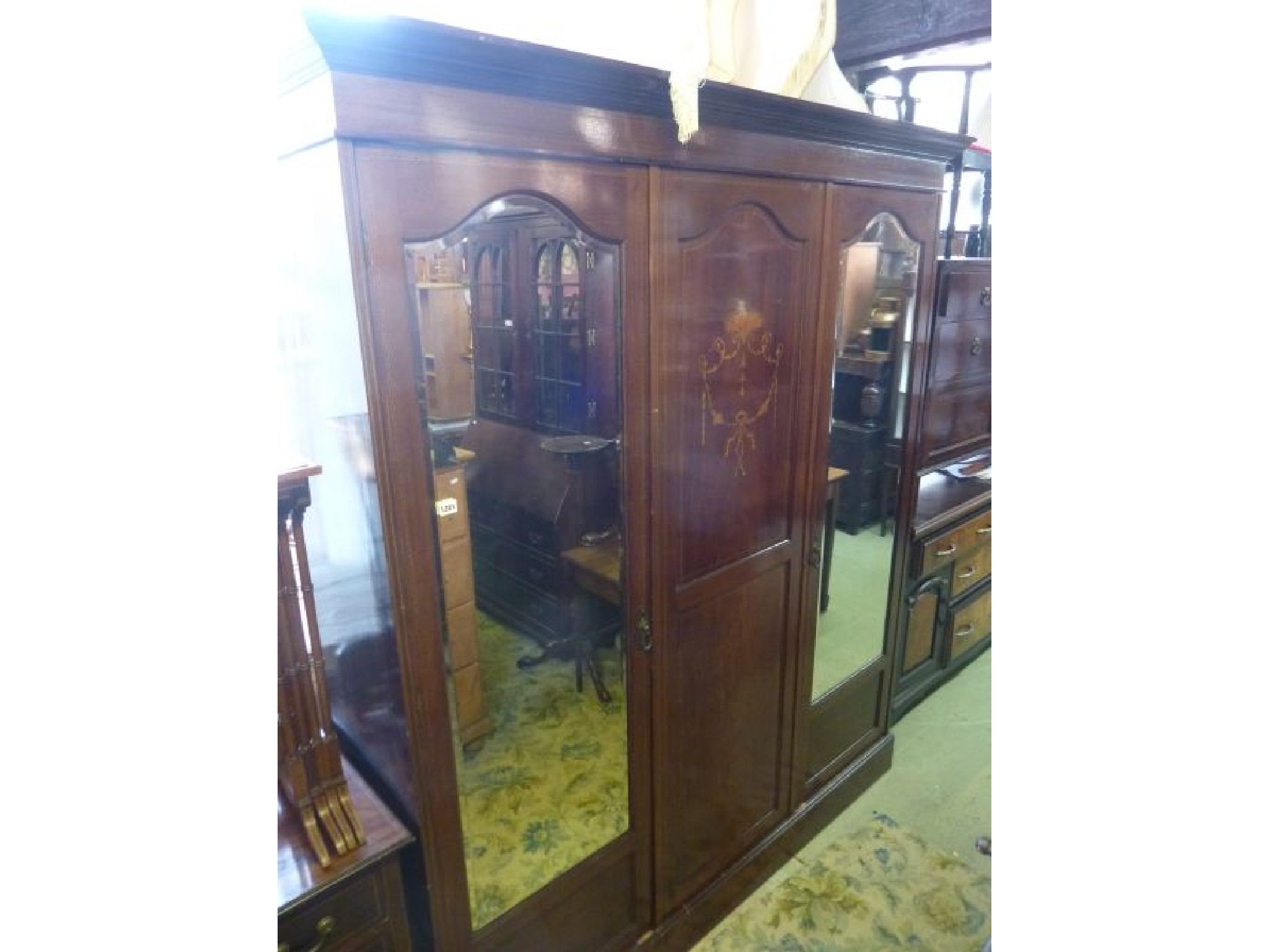 Appraisal: An inlaid Edwardian mahogany bedroom suite comprising a triple wardrobe