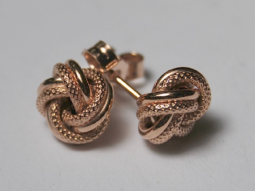 Appraisal: Pair of pink gold knot style pierced earrings