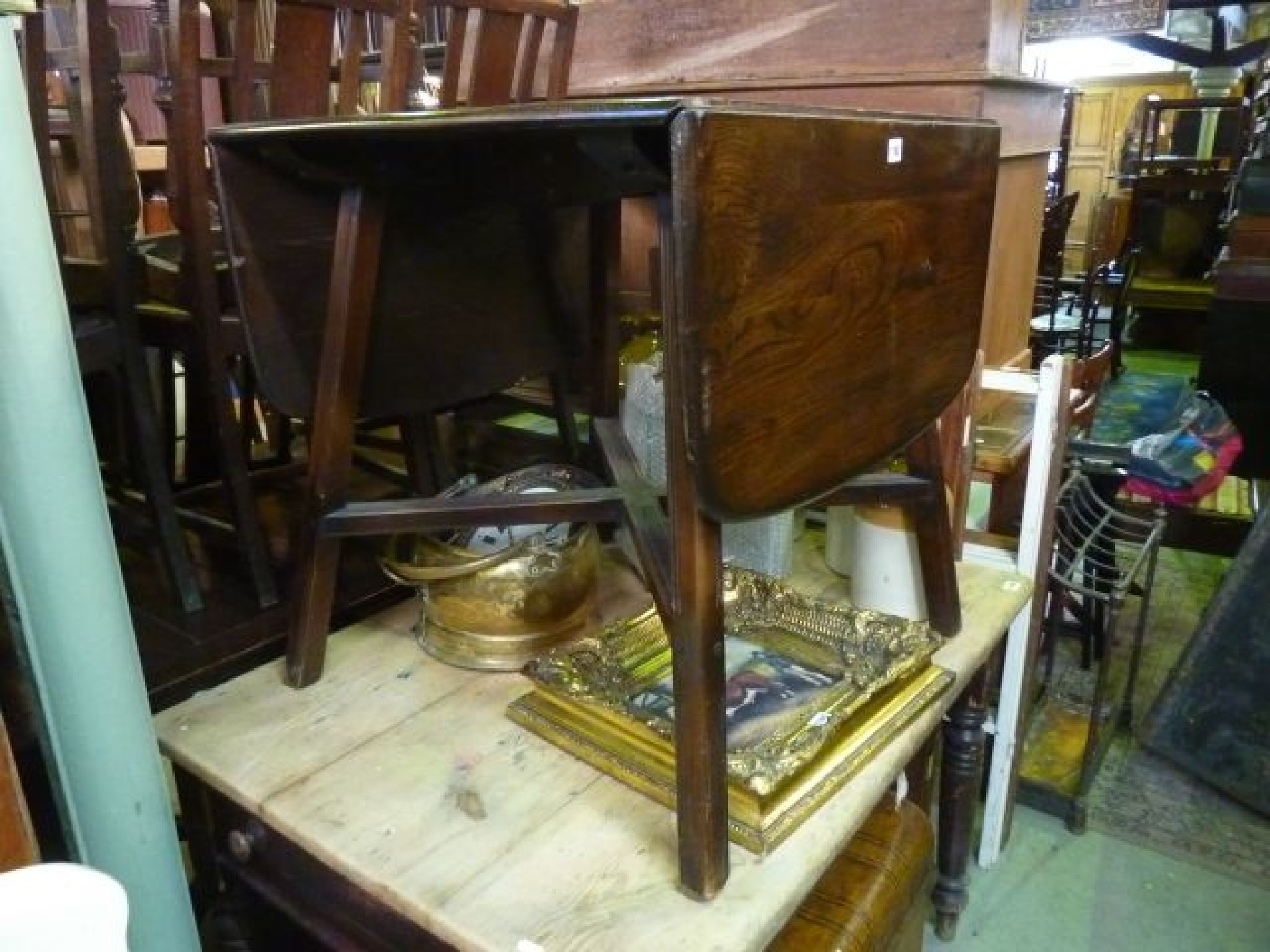 Appraisal: A mid brown Ercol drop leaf dining table in elm