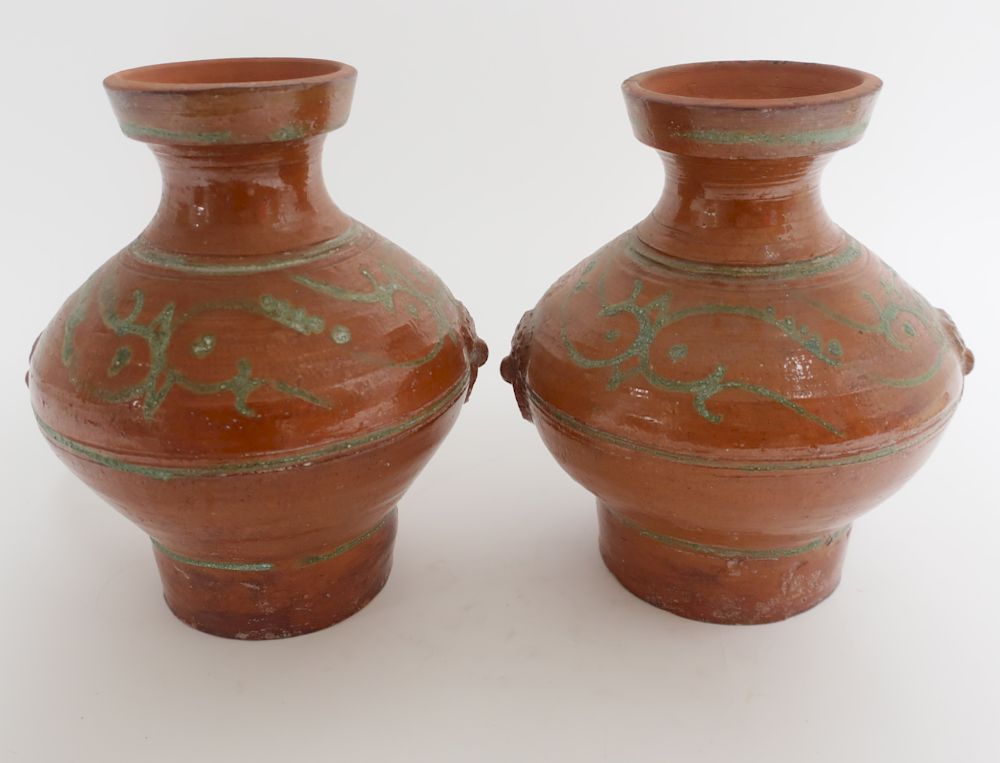 Appraisal: Two Matching Han Style Terracotta Hu Vases Nearly matching terracotta