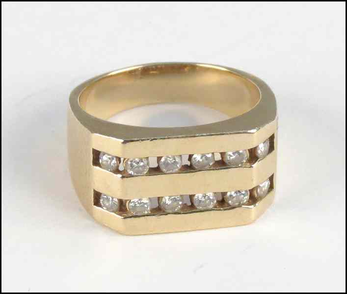 Appraisal: DIAMOND AND YELLOW GOLD RING Comprised of twelve channel set