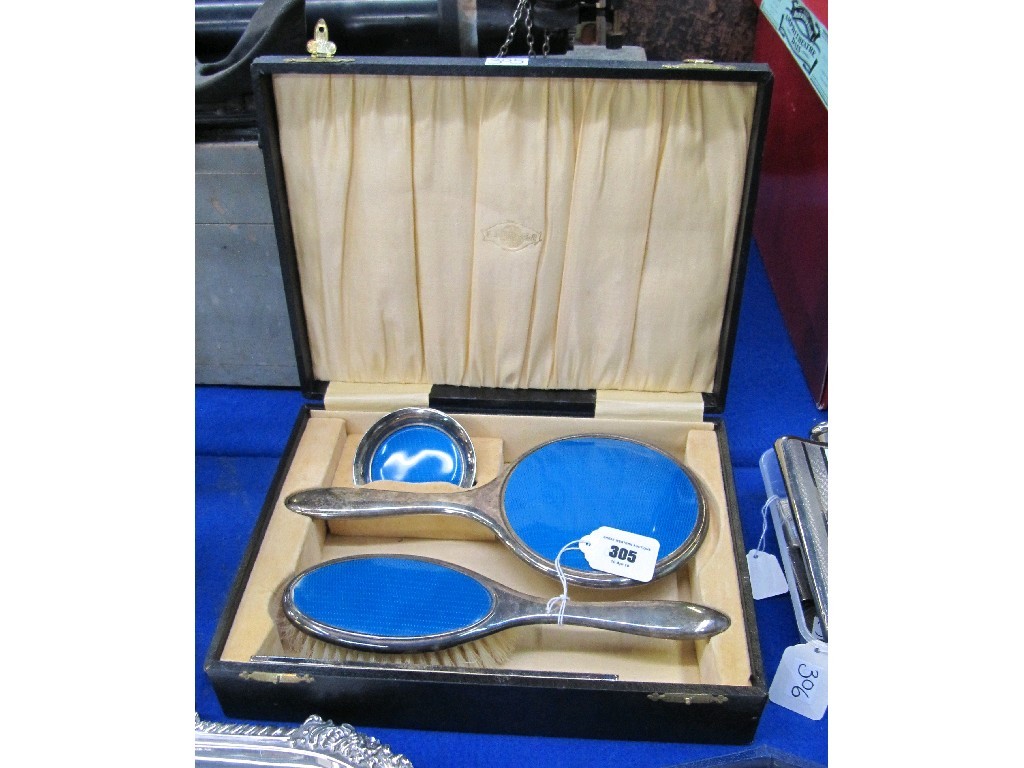 Appraisal: Cased three piece EPNS and enamel dressing table set