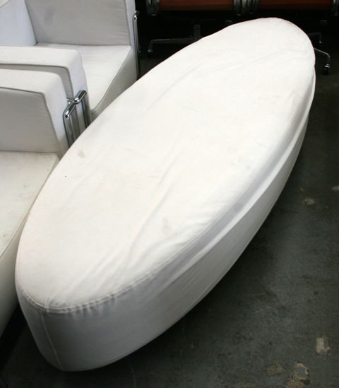 Appraisal: An elliptical shaped white upholstered seat