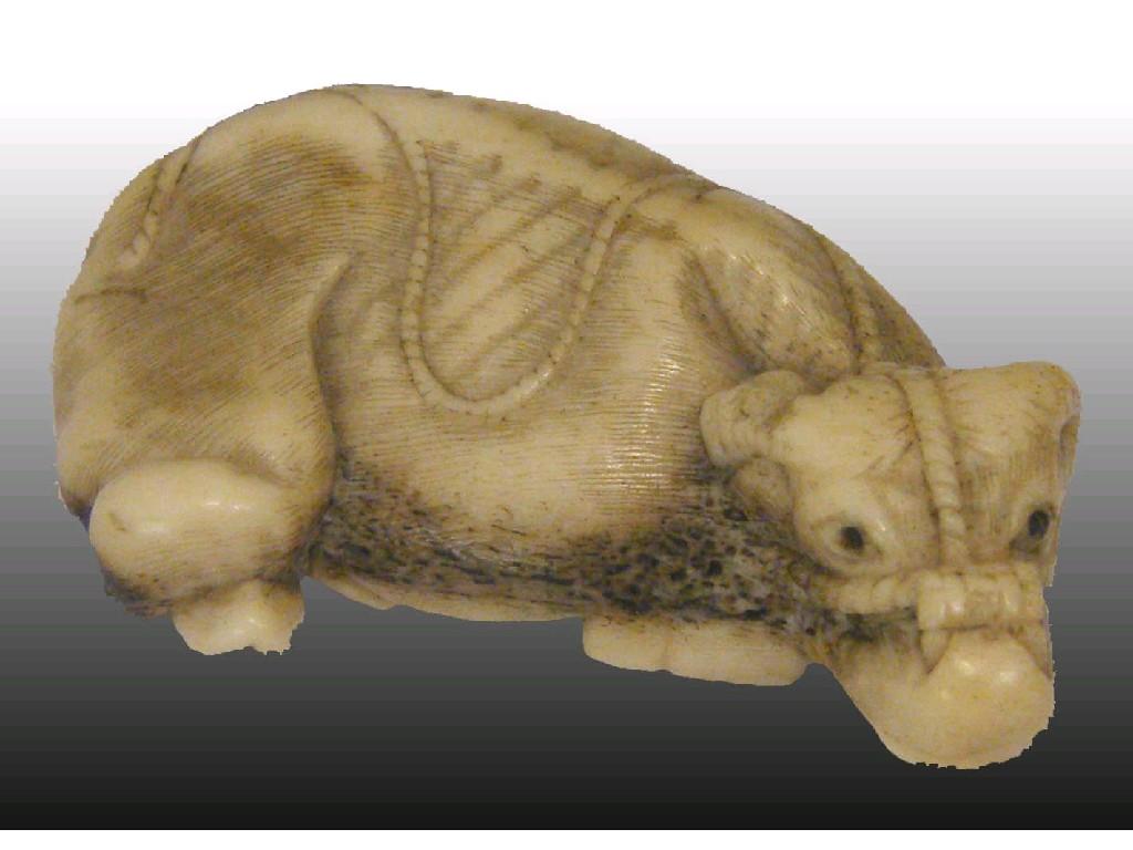 Appraisal: Interesting netsuke of a water buffalo modelled recumbent with its