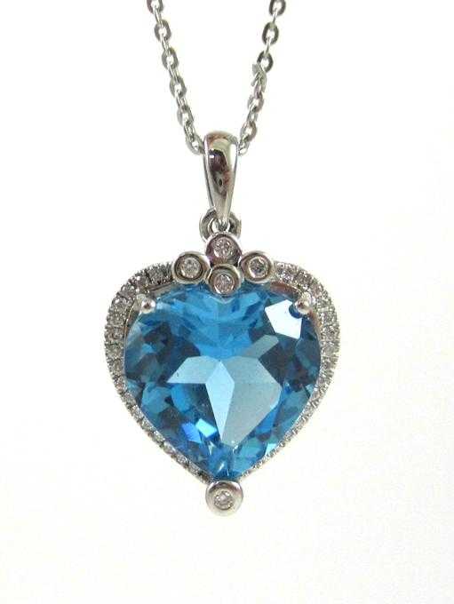 Appraisal: BLUE TOPAZ AND DIAMOND PENDANT NECKLACE with a inch k