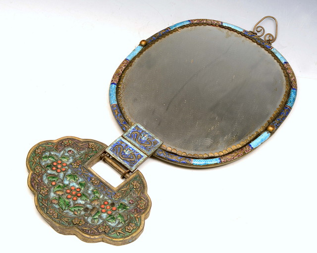 Appraisal: A CHINESE CANTON ENAMEL AND EMBOSSED METAL MIRROR of oval