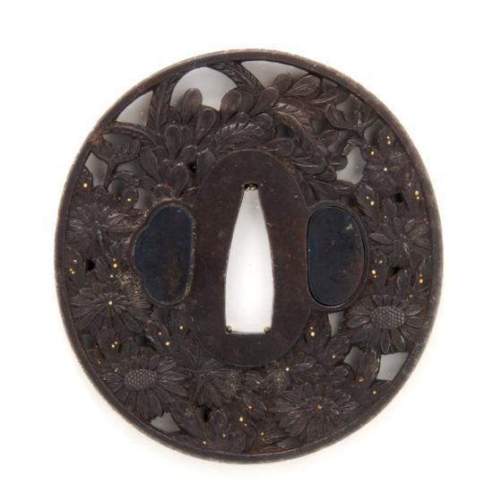 Appraisal: An Iron Choshu Tsuba pierce decorated with gold accents with