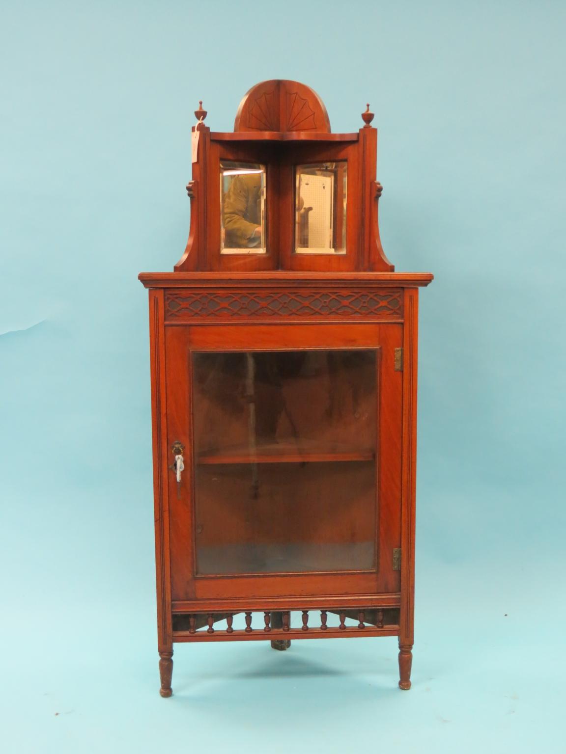 Appraisal: A late Victorian walnut corner-fitting display cabinet mirrored over-shelf above