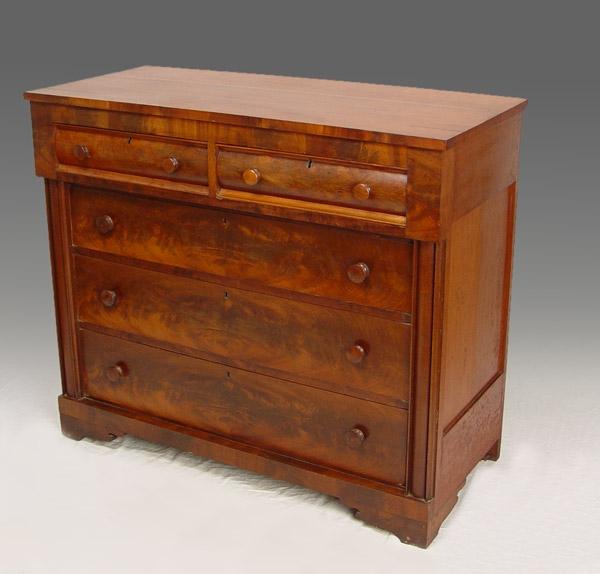 Appraisal: EMPIRE MAHOGANY VENEER OVER DRAWER CHEST Flame mahogany matched veneer