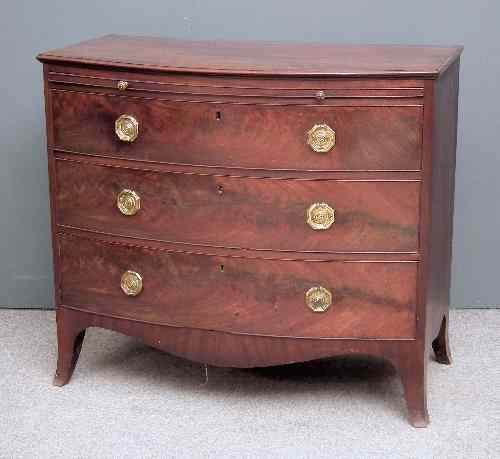 Appraisal: A George III mahogany bow-front chest of drawers the top