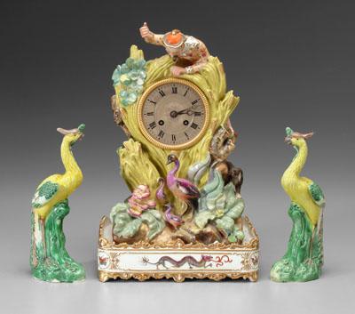 Appraisal: Clock with porcelain stand Asian gentleman above metal clock face