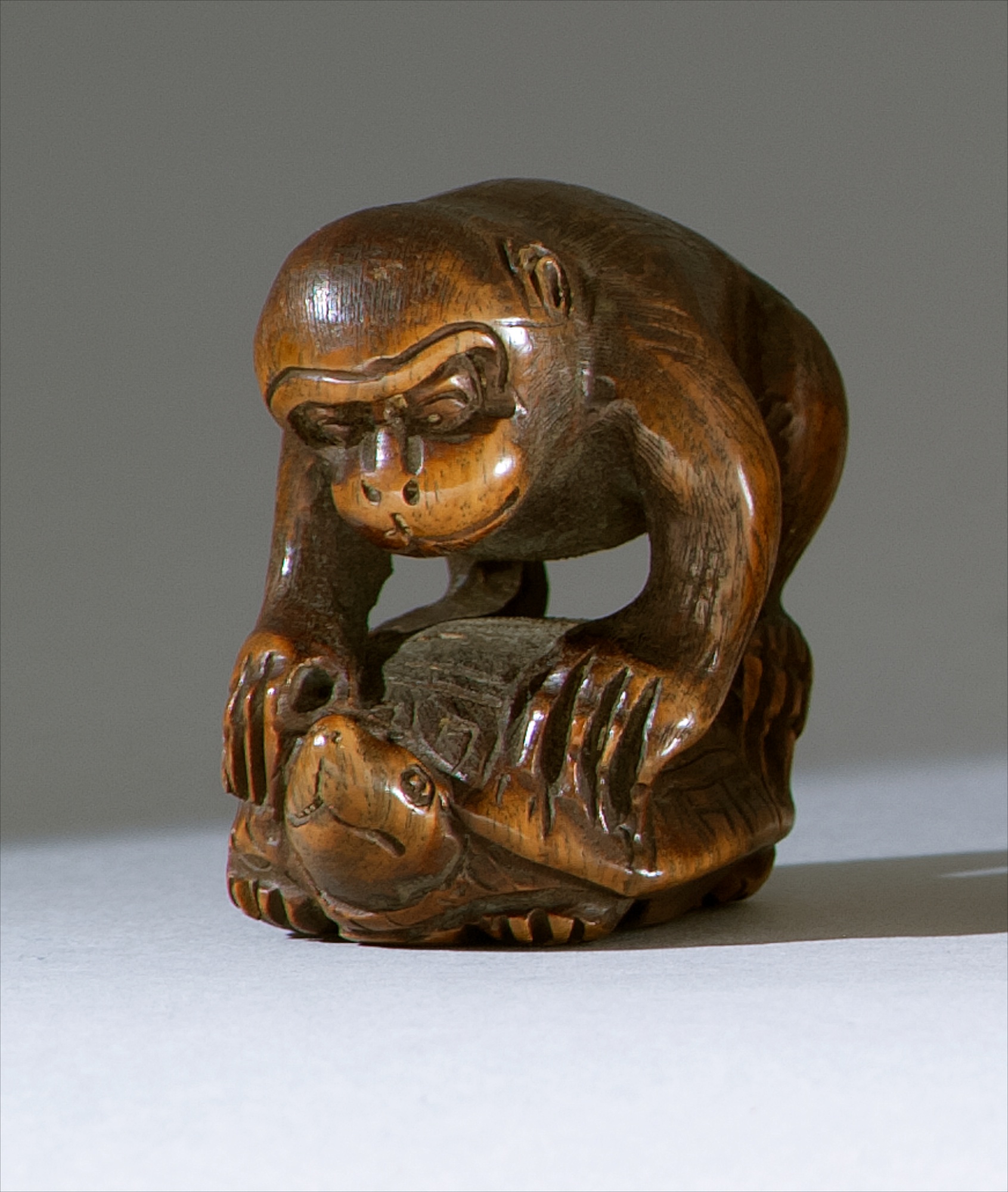 Appraisal: WOOD NETSUKE th CenturyIn the form of a monkey riding