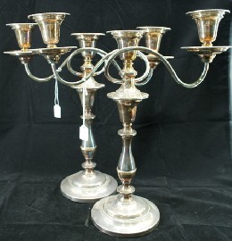 Appraisal: A pair of weighted English silver plate three branch candlesticks