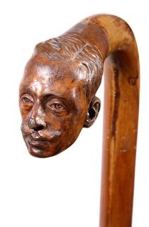 Appraisal: Folk-Art Portrait Cane Ca A malacca shaft with a carved