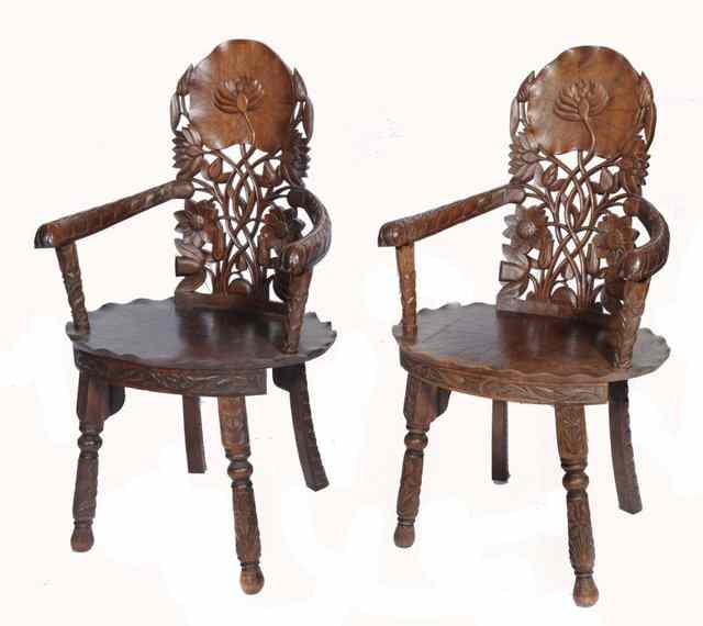 Appraisal: A PAIR OF NORTH INDIAN CARVED HARDWOOD CHAIRS with lily