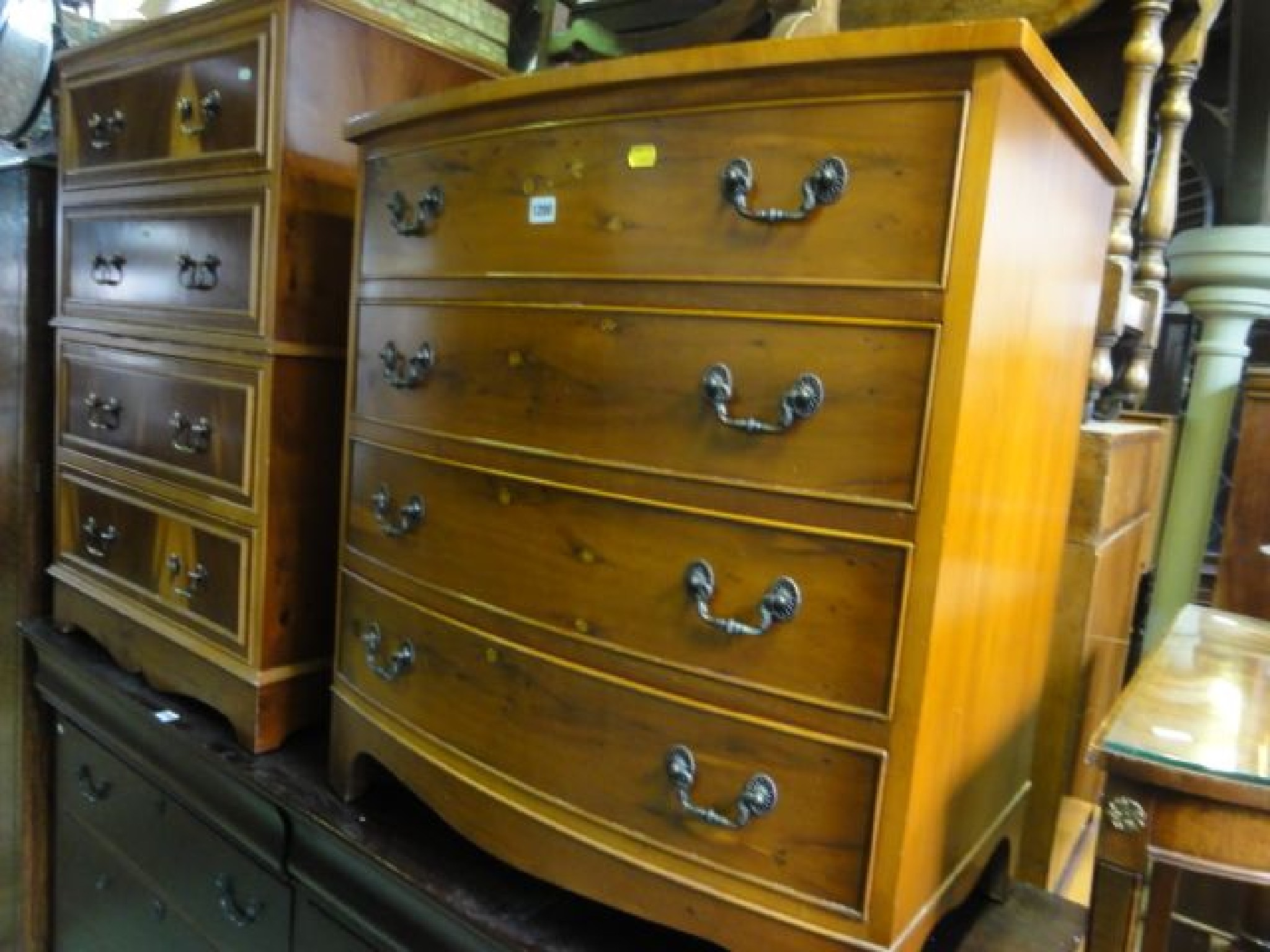 Appraisal: A reproduction yew wood veneered bow fronted bedroom chest of