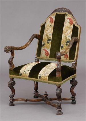 Appraisal: FLEMISH-CARVED AND UPHOLSTERED ARMCHAIR The arched carved cresting above a