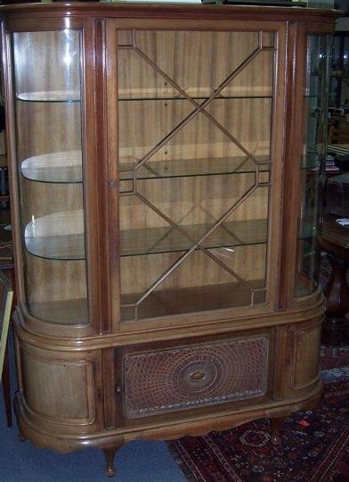 Appraisal: A mahogany display cabinet the astragal glazed panel door and