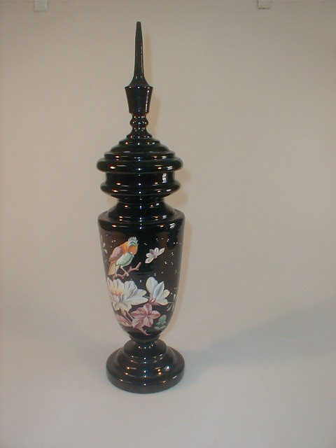 Appraisal: A thC black glass vase and cover with a moulded