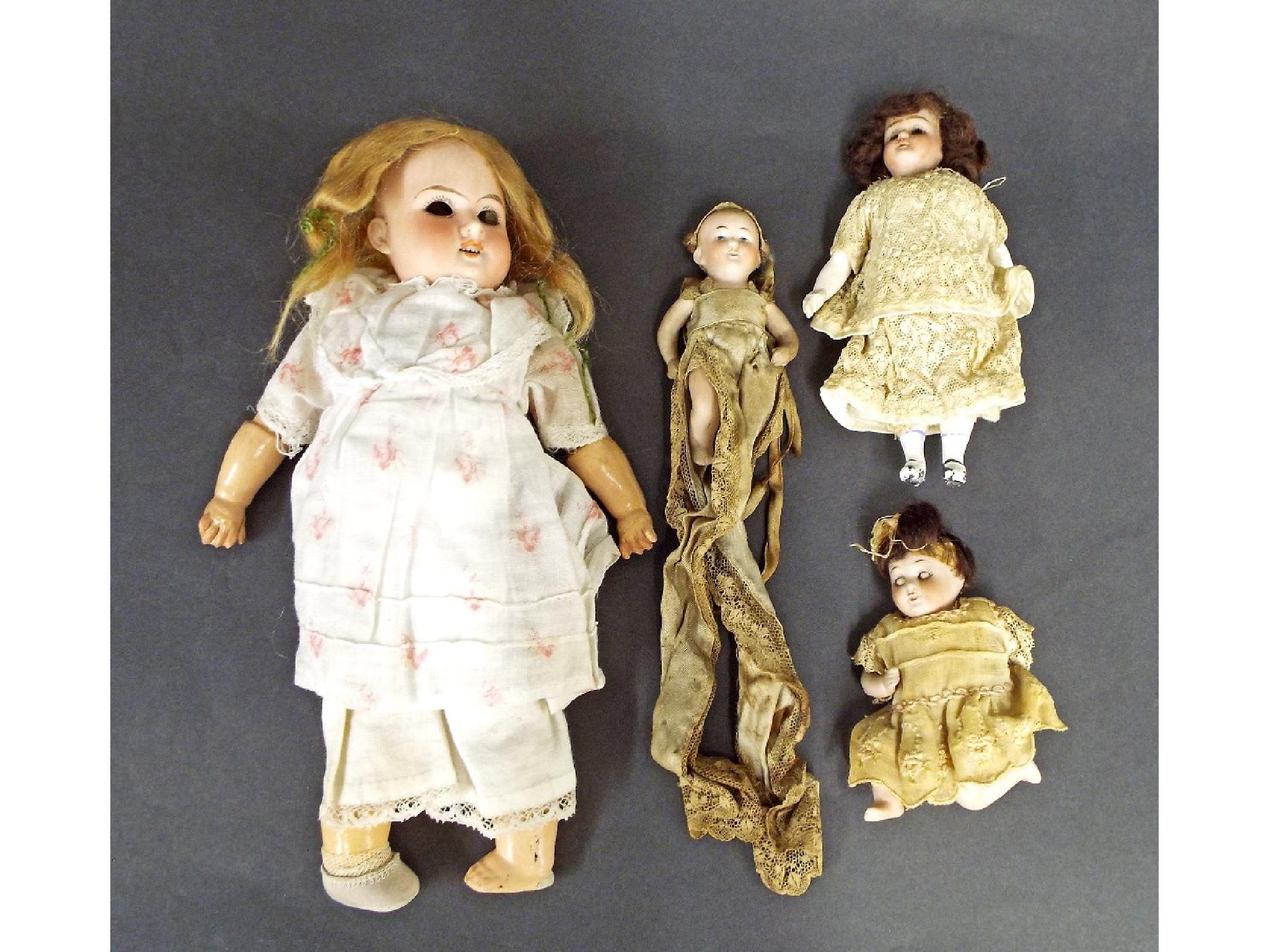 Appraisal: Two miniature porcelain dolls both with articulated limbs one with