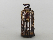 Appraisal: A miniature tortoiseshell bird cage the two-dimensional bird to the