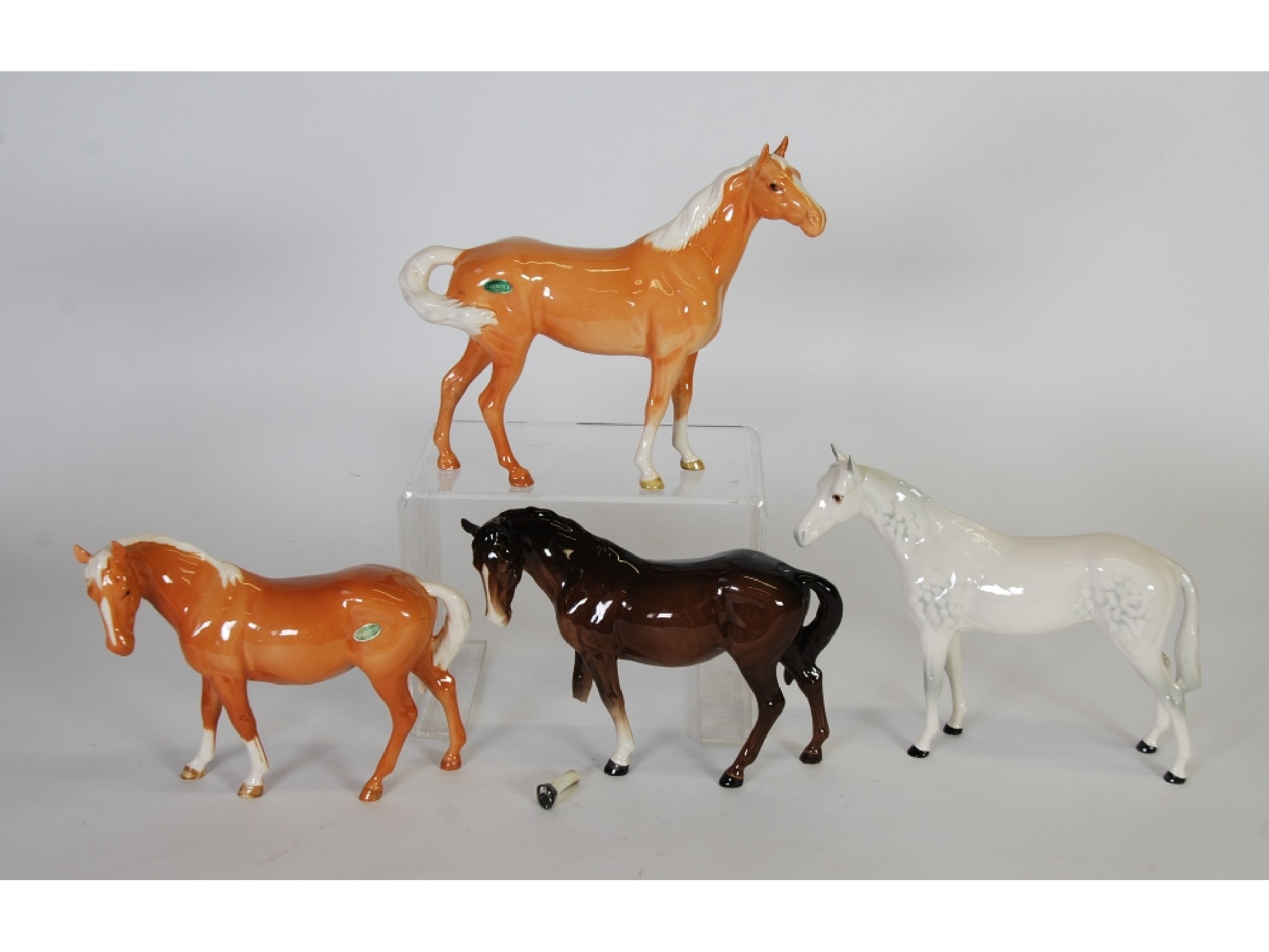 Appraisal: THREE BESWICK POTTERY HORSES comprising MARE FACING LEFT palomino and