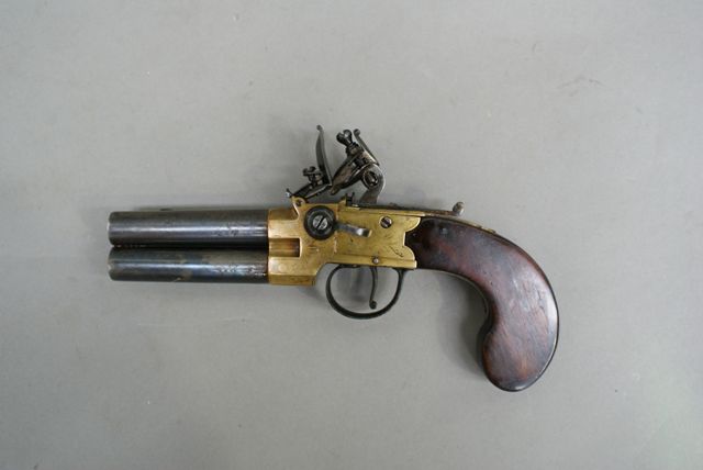 Appraisal: A British tap action over and under flintlock pistol caliber