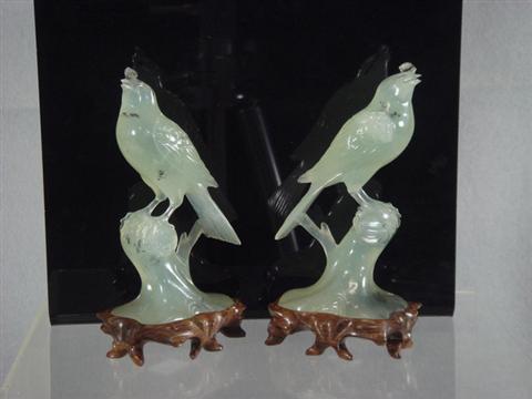 Appraisal: Pr carved light green jade song birds th th c