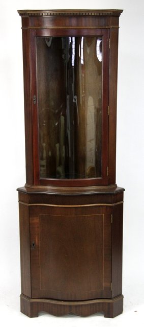 Appraisal: A th Century serpentine mahogany standing corner cupboard with glazed